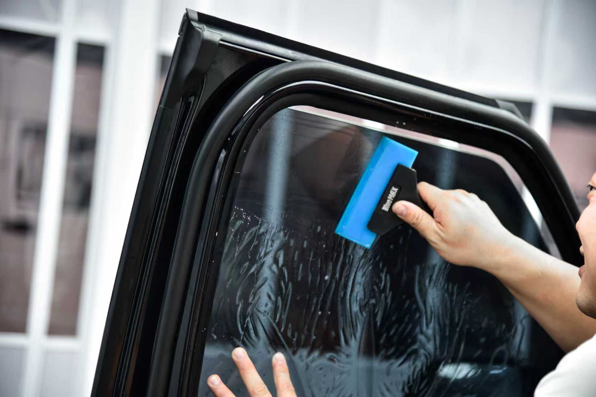 Heat rejection window tint being installed on side glass