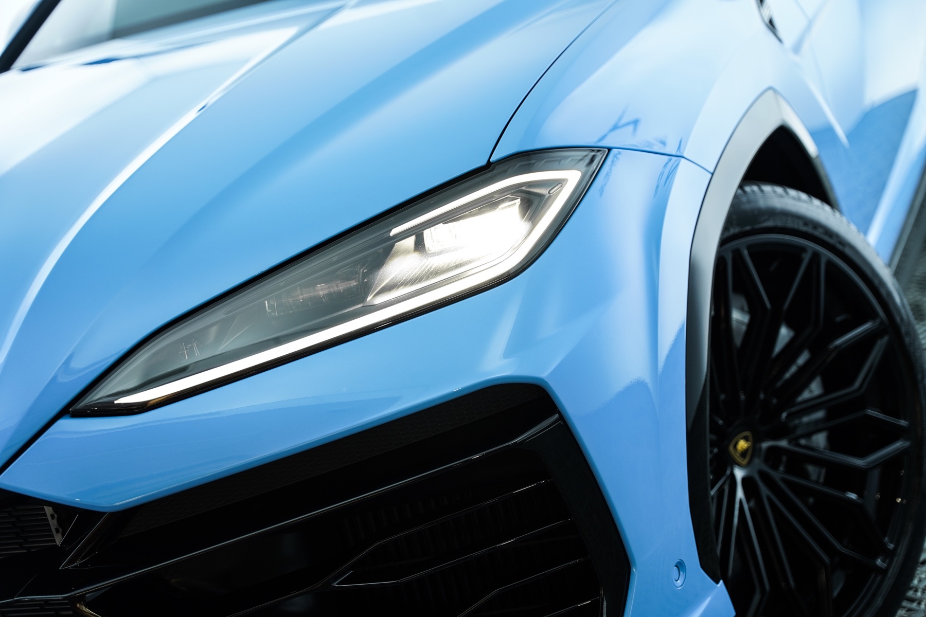 Blue Lamborghini Urus front corner and headlight detail