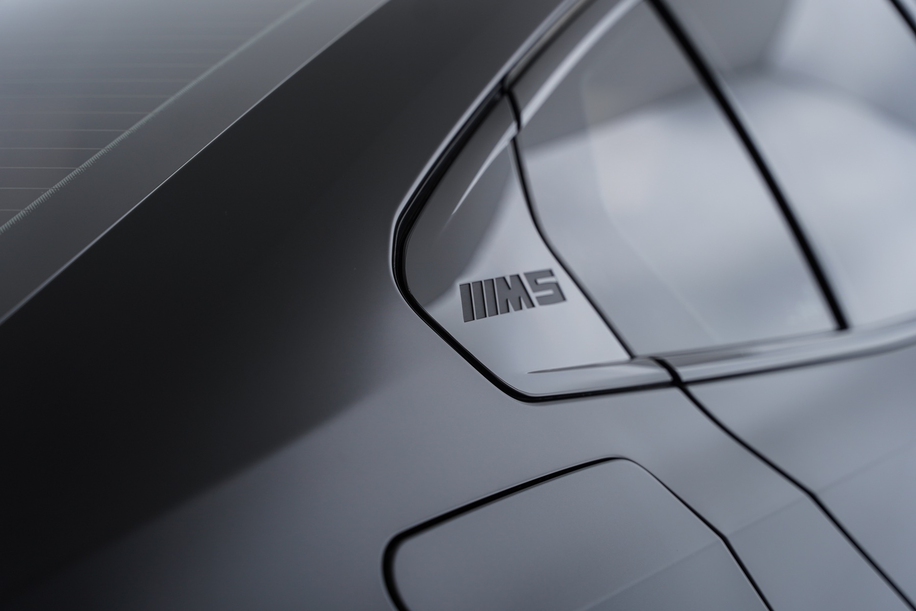 Grey BMW M5 badge and rear panel detail