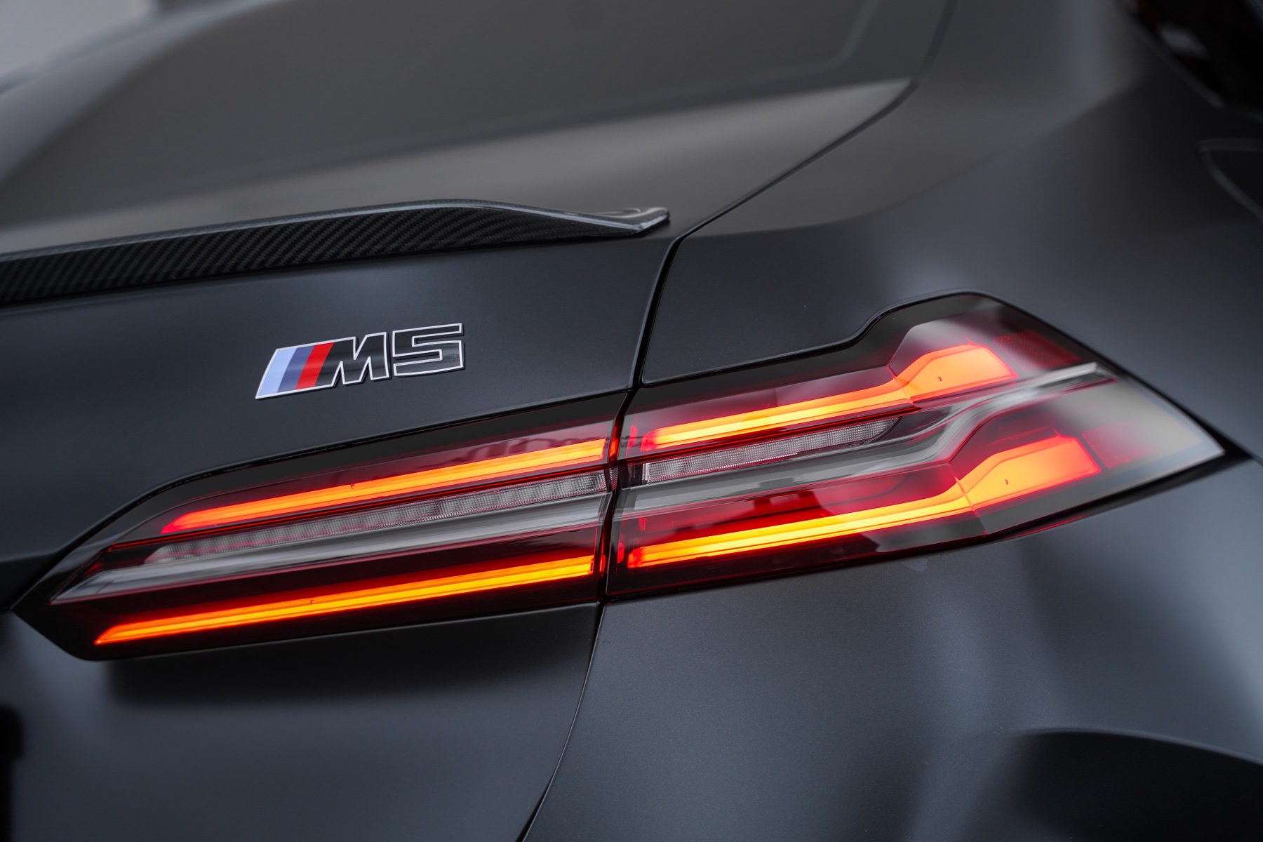 Grey BMW M5 rear light and wrapped panel detail
